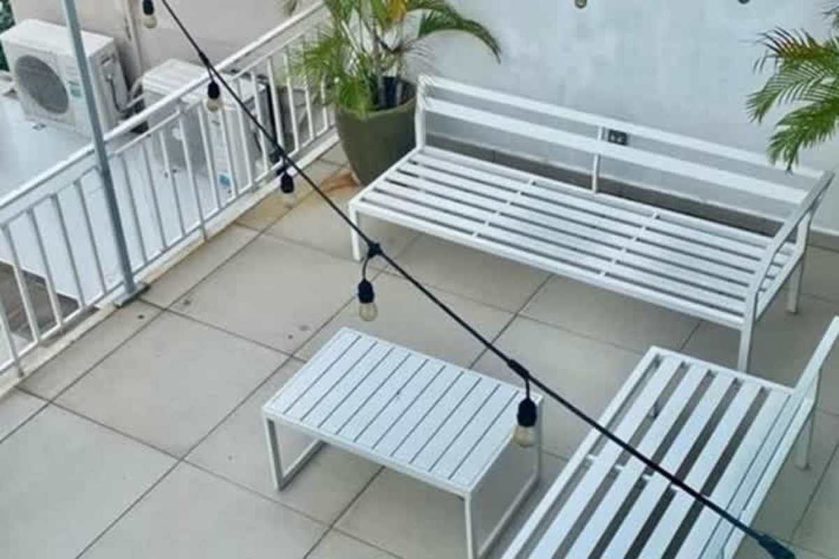 Dining area with white cabinetry, modern lighting, terrace access in La Alameda Betania Panama house