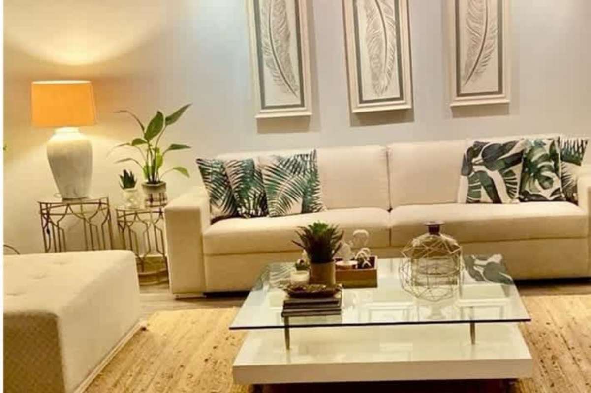 Contemporary media living room with large TV, guitar and eclectic decor in remodeled Betania Panama house