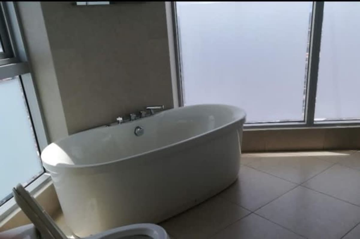 Spacious bathroom with large tub and window PH BICSA Tower Apartment