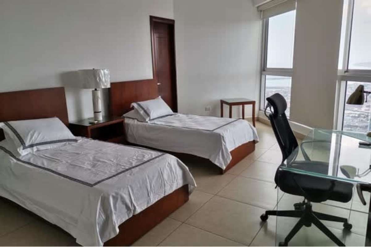 Modern open kitchen and living room with large windows facing ocean at PH BICSA Financial Center Panama City