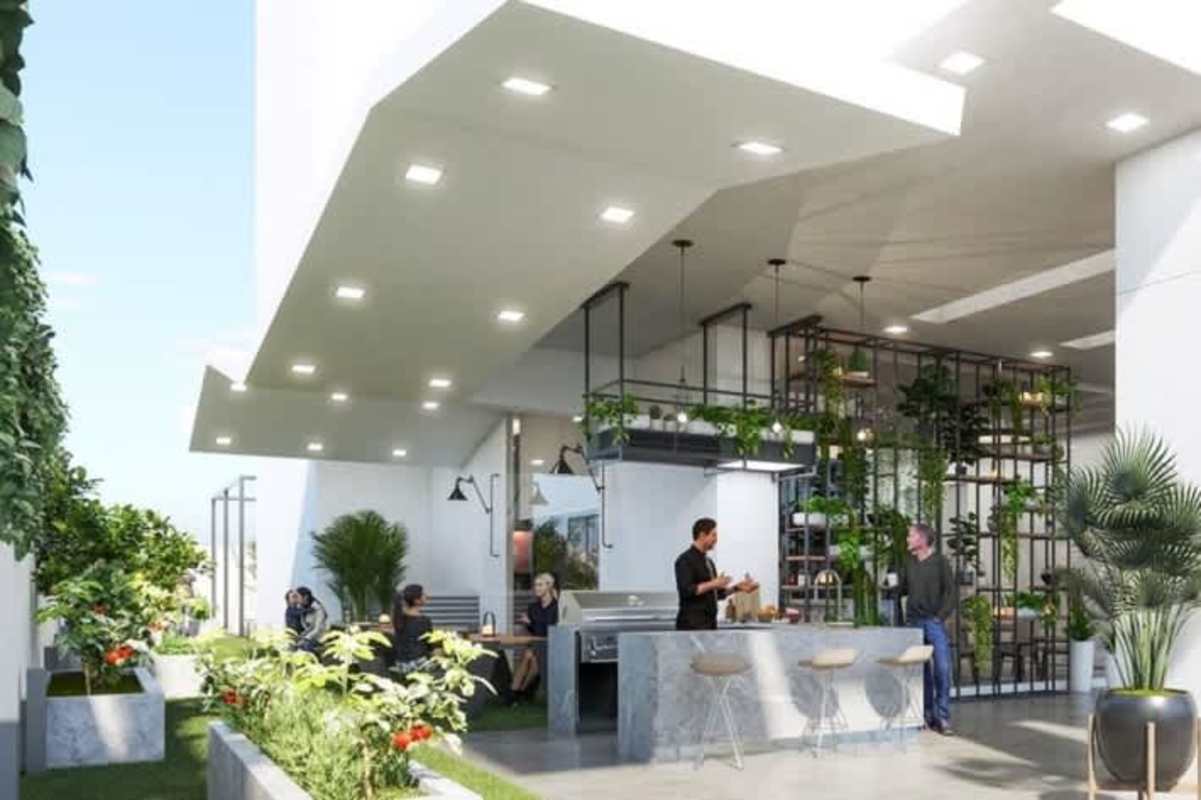 Outdoor communal lounge and kitchen with greenery at PH Next luxury condos Coco del Mar Panama City