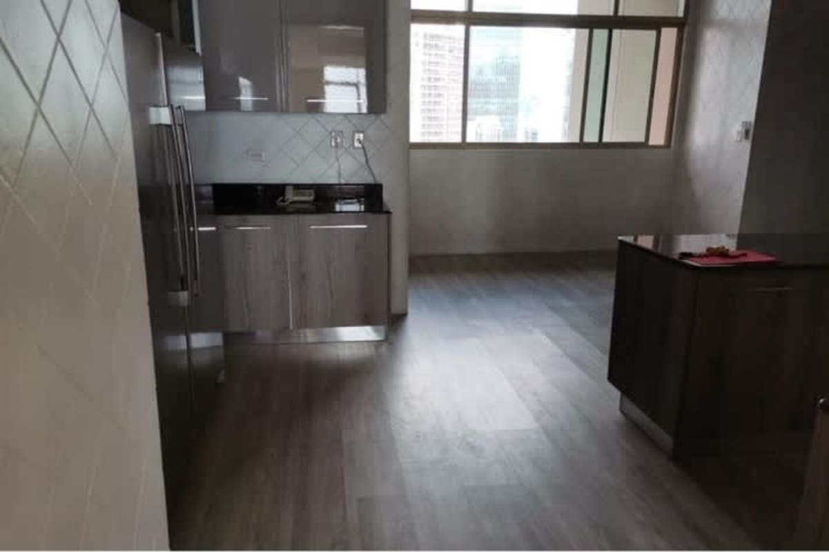 Modern kitchen with granite island, stainless steel appliances, floor-to-ceiling windows in PH Ocean Club Punta Pacifica Panama