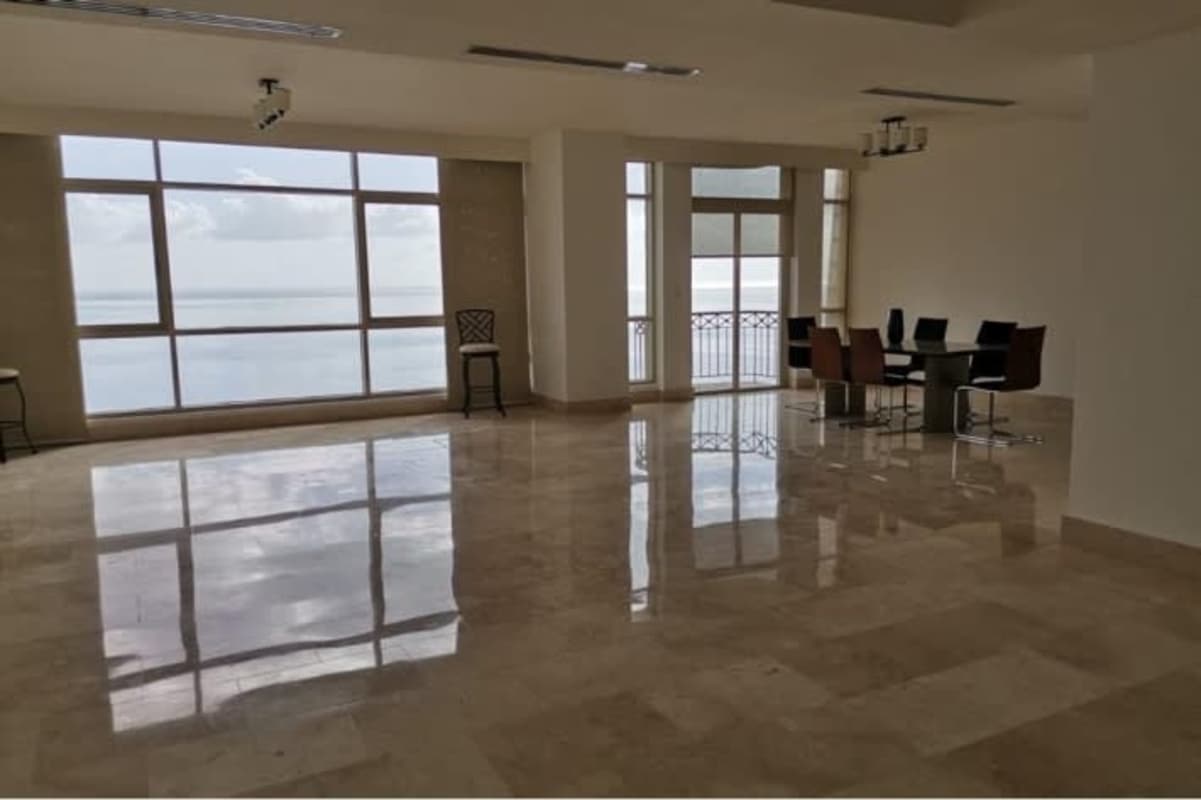 Dining area with marble flooring, large windows and balcony access ocean views in PH Ocean Club Punta Pacifica Panama
