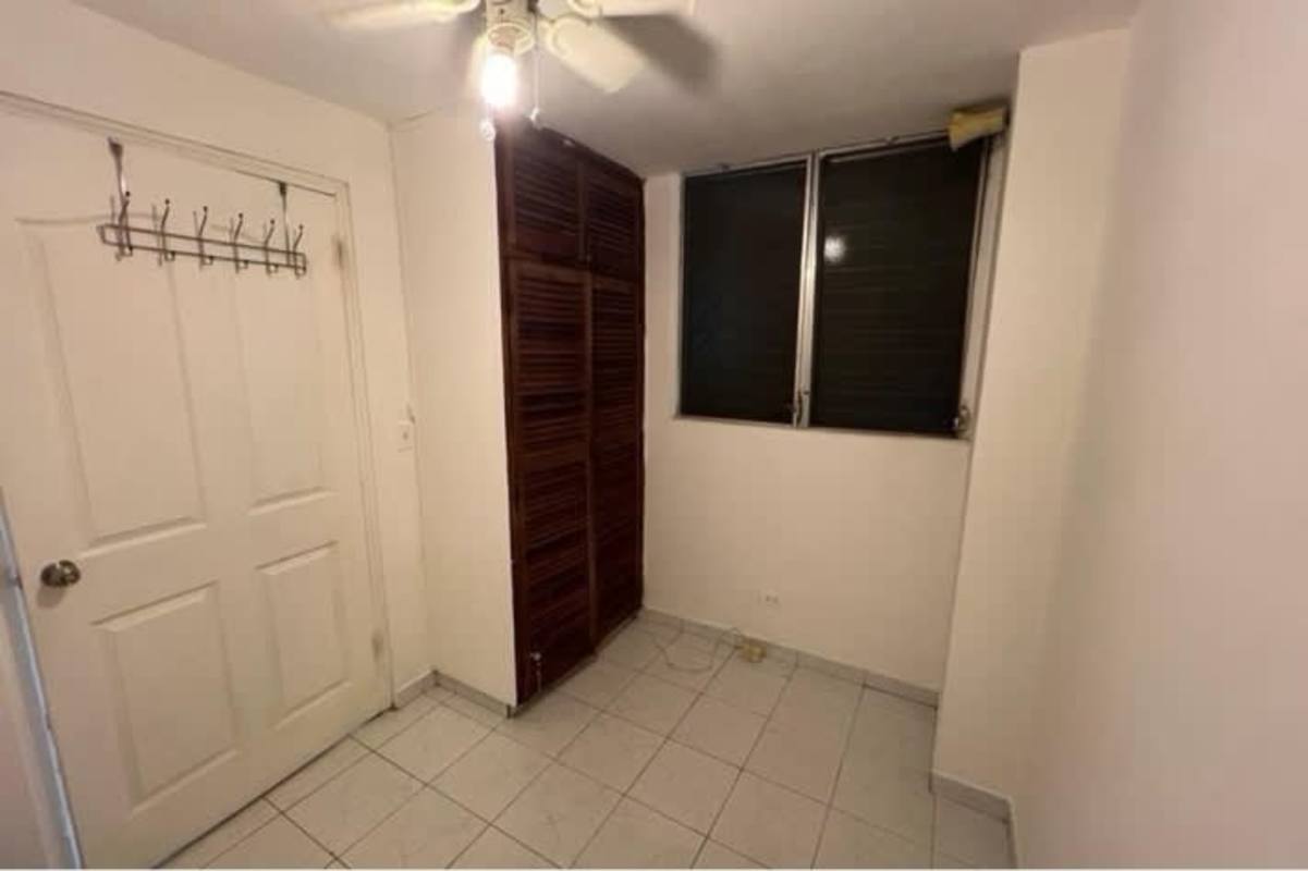 Living dining area with open kitchen and tile floor in PH San Francisco Panama City