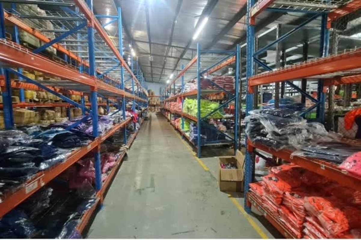 Storage aisle inside industrial warehouse with racks of packaged items La Locería Betania Panama