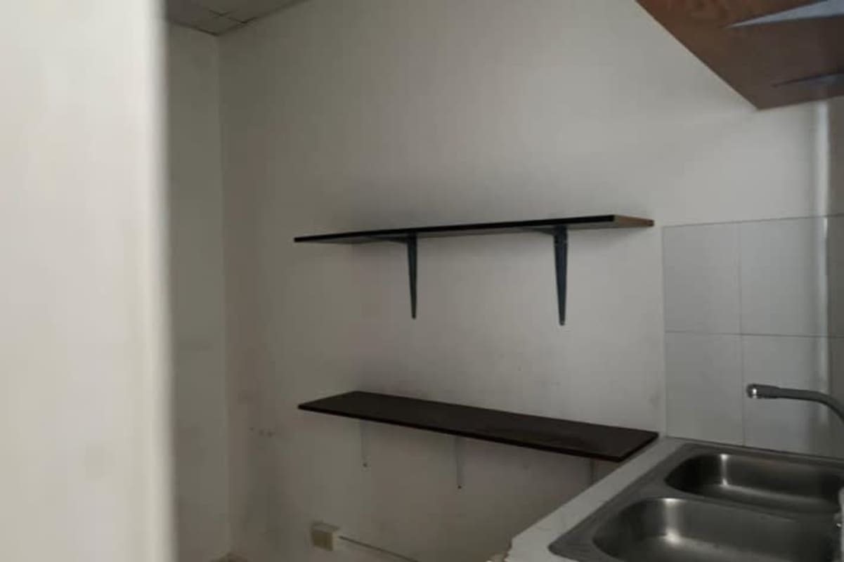 Kitchenette with double stainless sink and wall shelves at commercial unit San Miguelito Panama