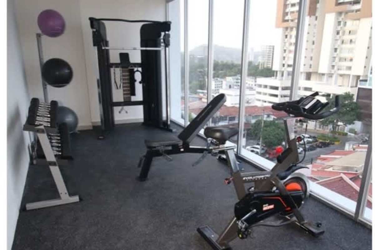 Fitness center with panoramic skyline view and workout equipment PH La Loma Tower Panama