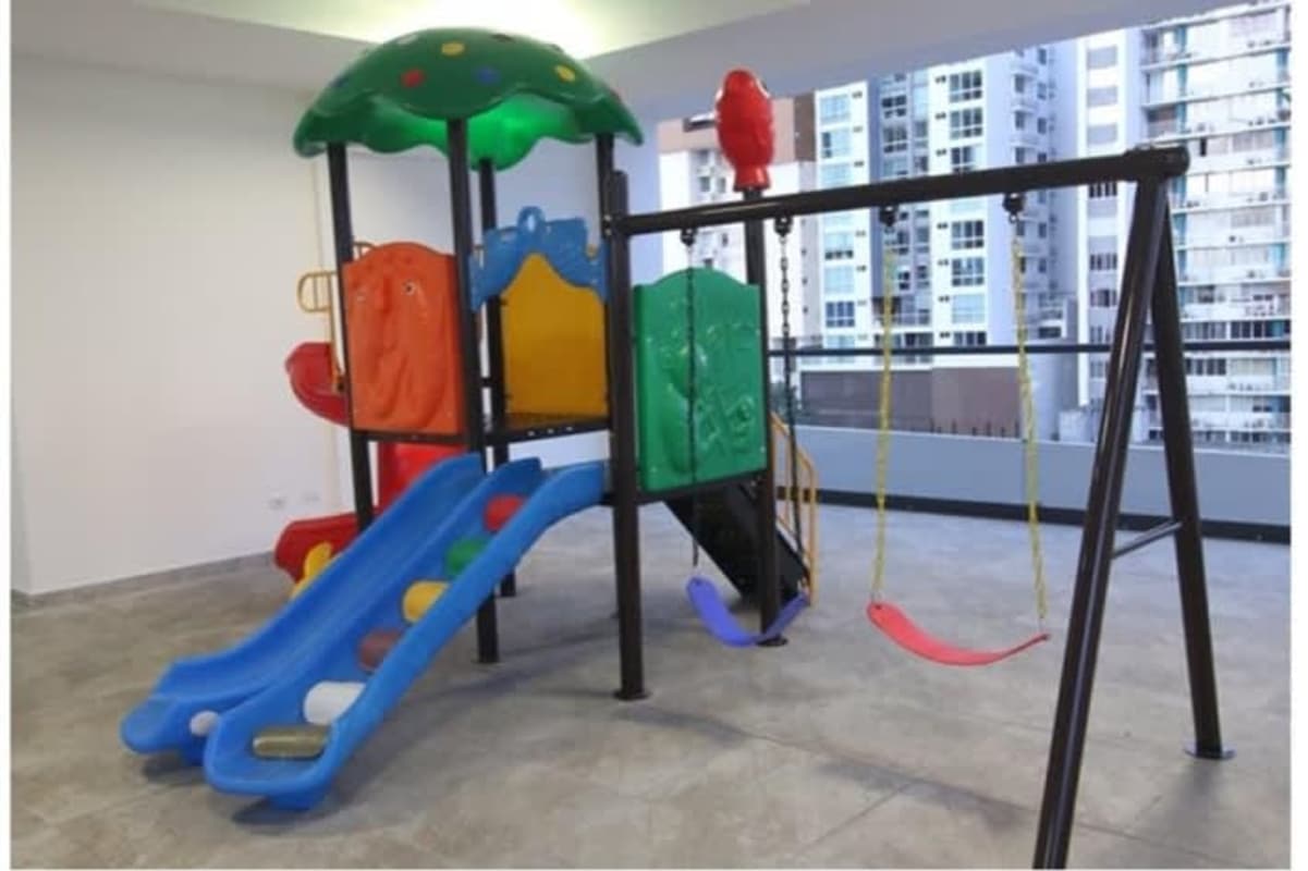 Colorful indoor children's recreational playground with slides swings PH La Loma Tower Panama
