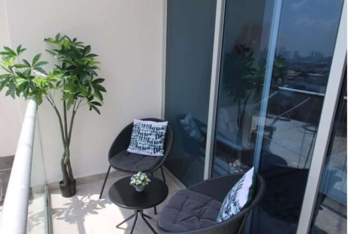 Balcony with glass railing and skyline views PH La Loma Tower Panama City apartment