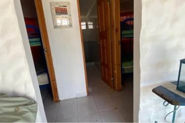 Cozy living room with tiled floor sofa windows tropical beach house Gorgona Panama