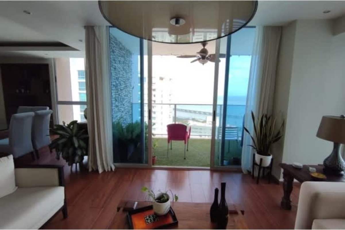 Elegant dining area with large windows overlooking cityscape at PH Mirador del Mar Panama City