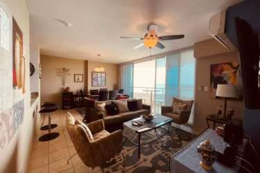 Master bedroom with large windows, ocean view, ceiling fan and closet at Playa Serena Resort Nueva Gorgona