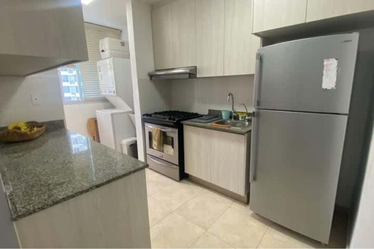 Modern kitchen with appliances, granite counter, stacked washer dryer PH Sky Blue Tower Panama