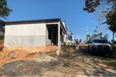 Partially built concrete block buildings and natural coastal vegetation Veraguas Panama