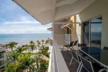 Covered balcony with dining table and Pacific Ocean views in Buenaventura luxury apartment
