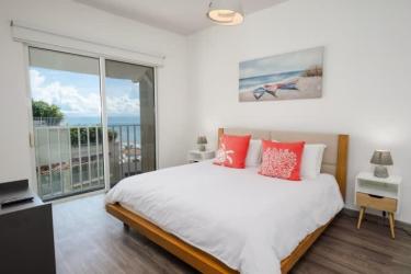 Bright living dining area with floor to ceiling windows ocean views PH Puntarena Buenaventura