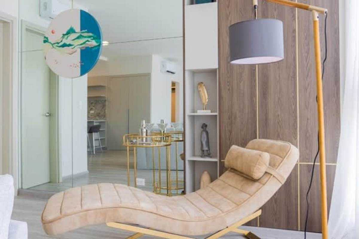 Modern living room with sofa, mirror wall, pastel accents at PH Skypark Costa del Este Panama