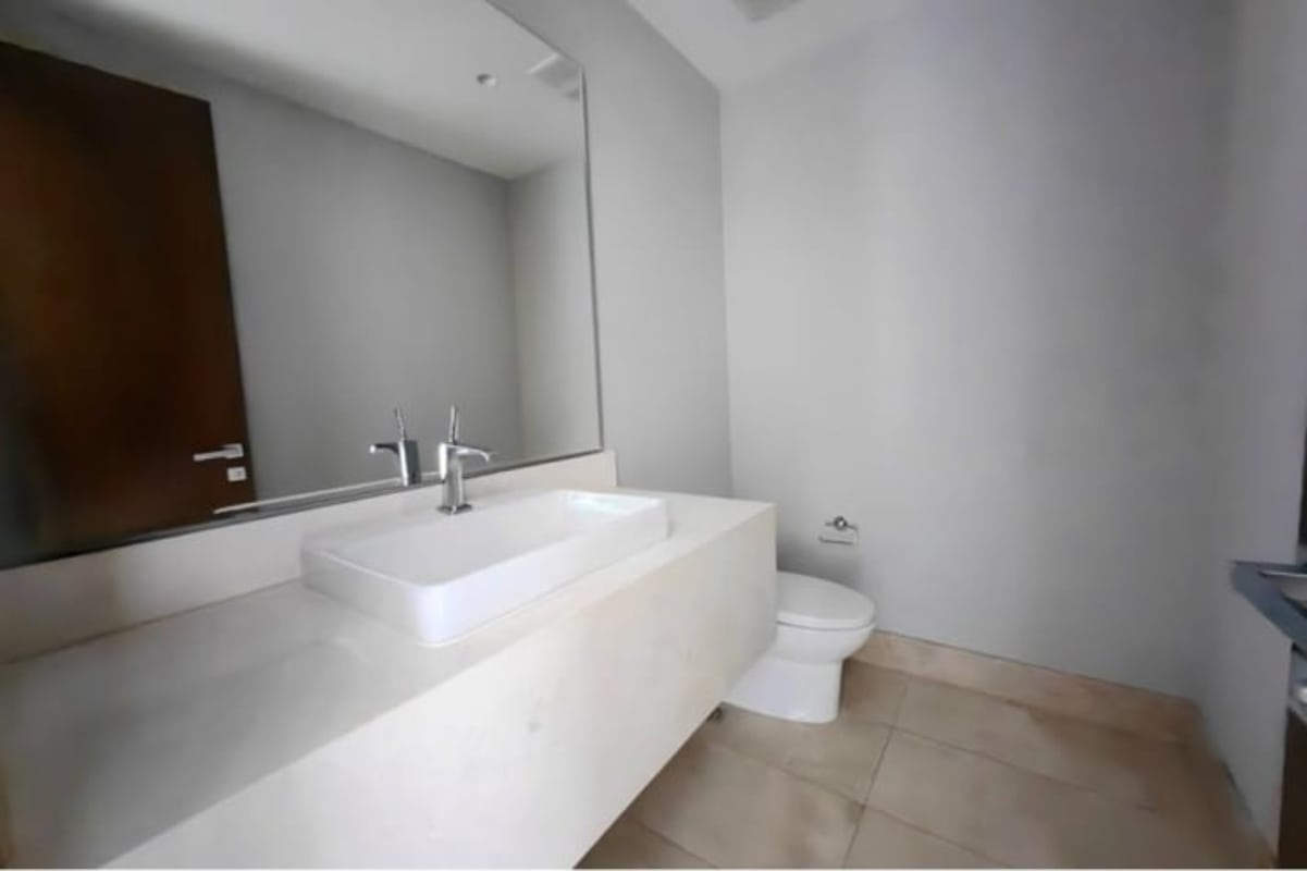 Spacious master bedroom with marble floors and panoramic windows in Santa Maria Panama