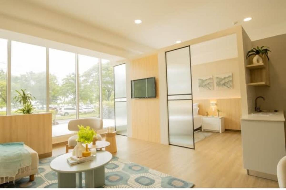 Living dining area with large windows, balcony access, and minimalist furniture in Sky Balboa Tower Panama