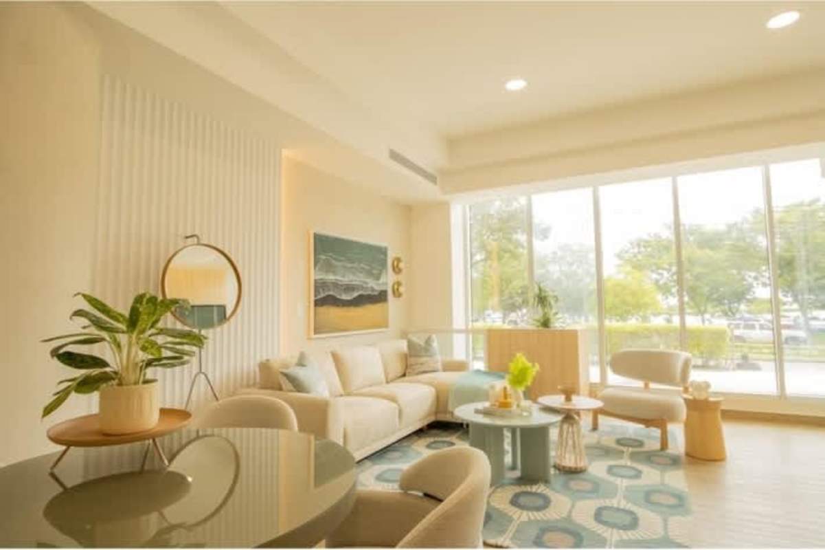 Bright living room with floor-to-ceiling windows, modern decor, and city skyline views in Sky Balboa Tower Panama