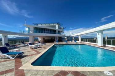 Living room with large windows and ocean views in PH Coronado Bay Coronado