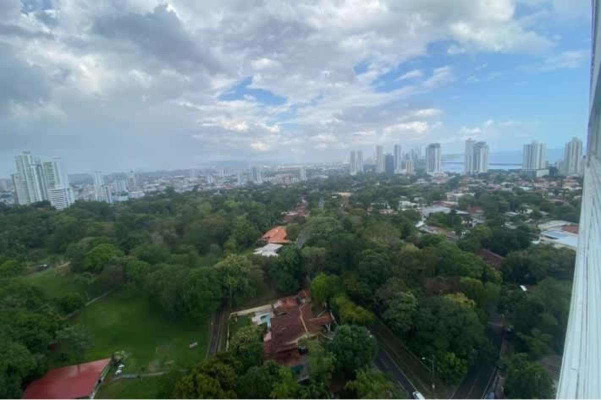 Kitchen featuring granite island, stainless steel appliances, and laundry area in PH Parque Omar Panama City
