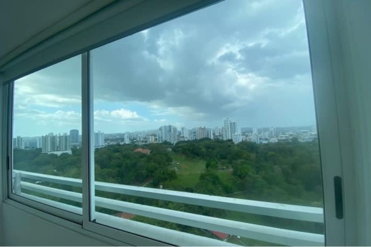 Bright bedroom with cityscape views in PH Parque Omar Panama City