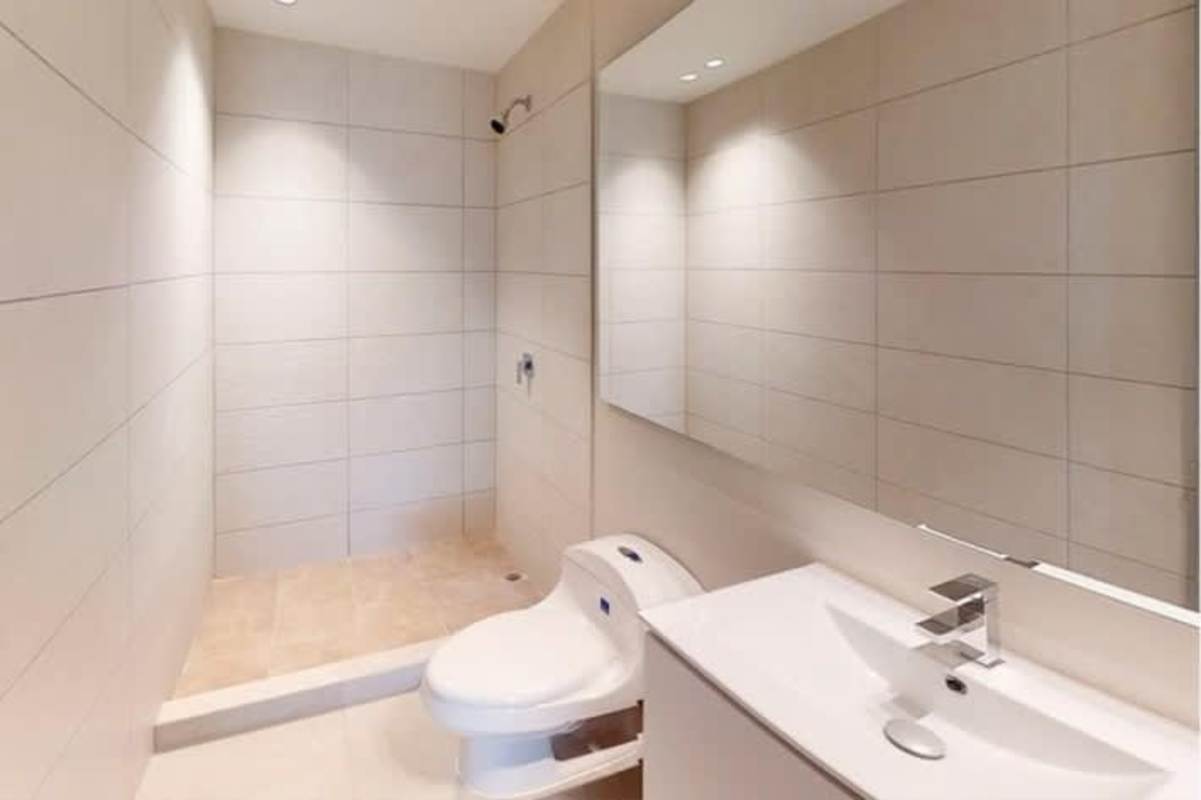 Modern open living and dining room with balcony access at PH Midtown El Cangrejo Panama