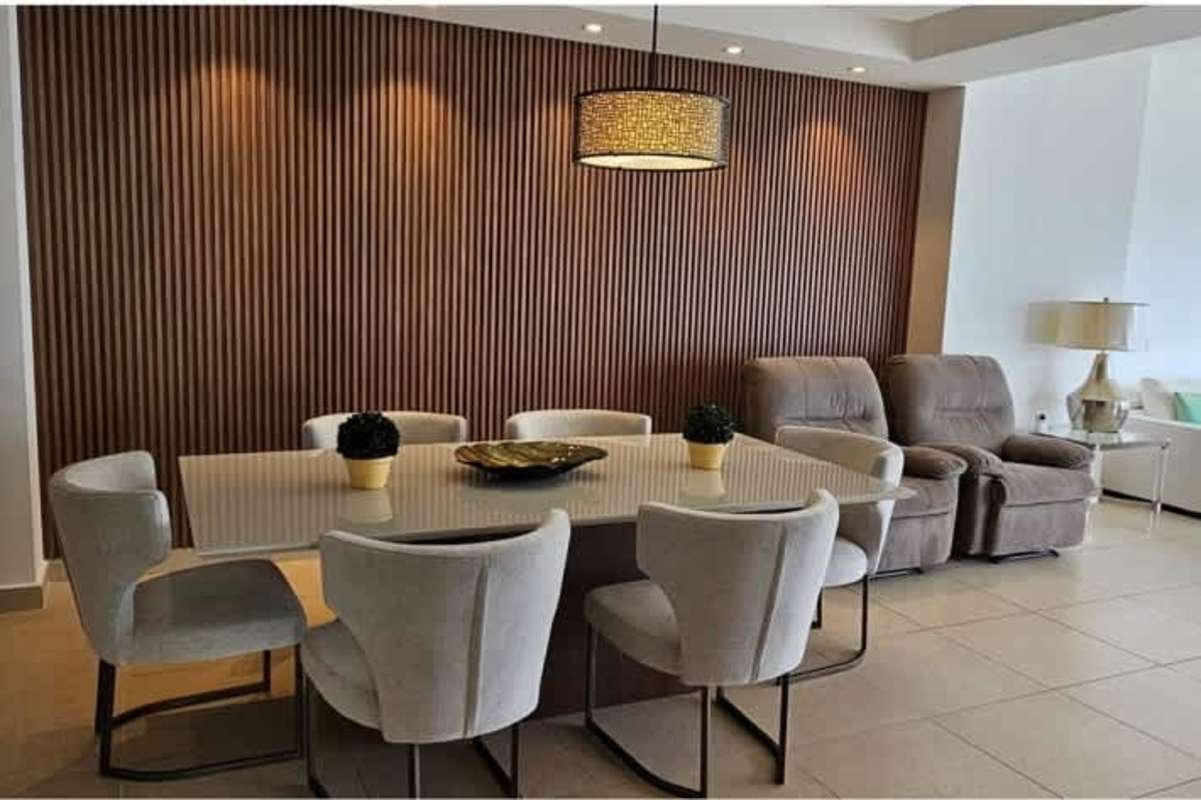 Contemporary kitchen with wood cabinetry, stainless appliances, breakfast bar in PH Rivage Tower Panama