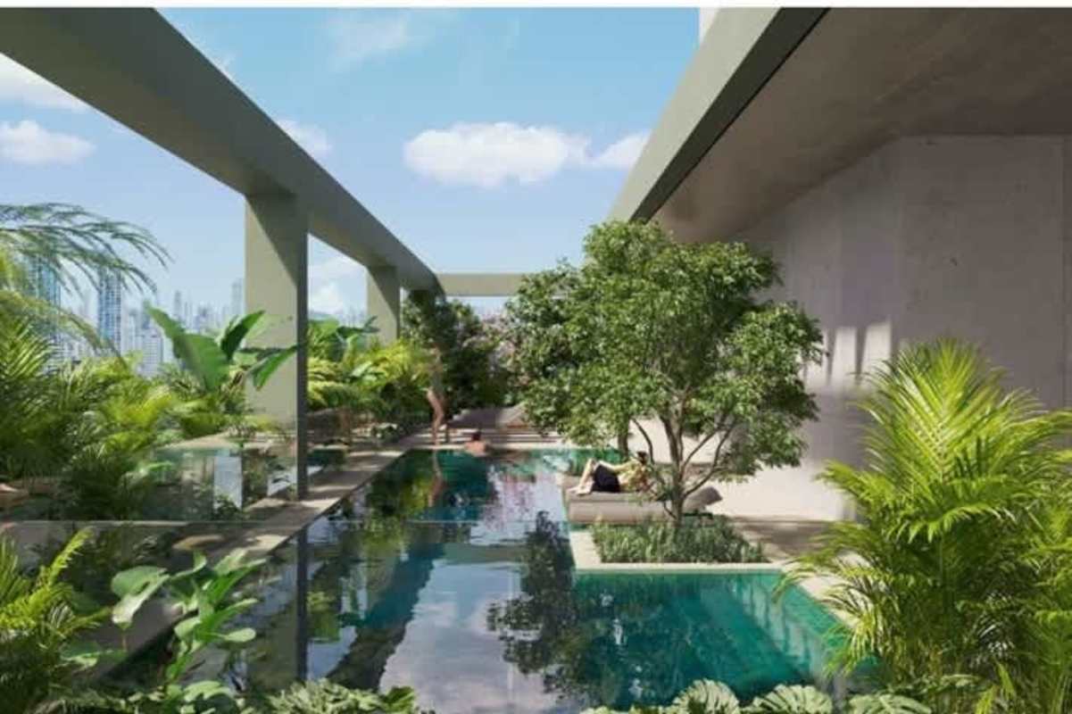 Infinity rooftop pool surrounded by tropical landscaping overlooking city at Coco del Mar Panama