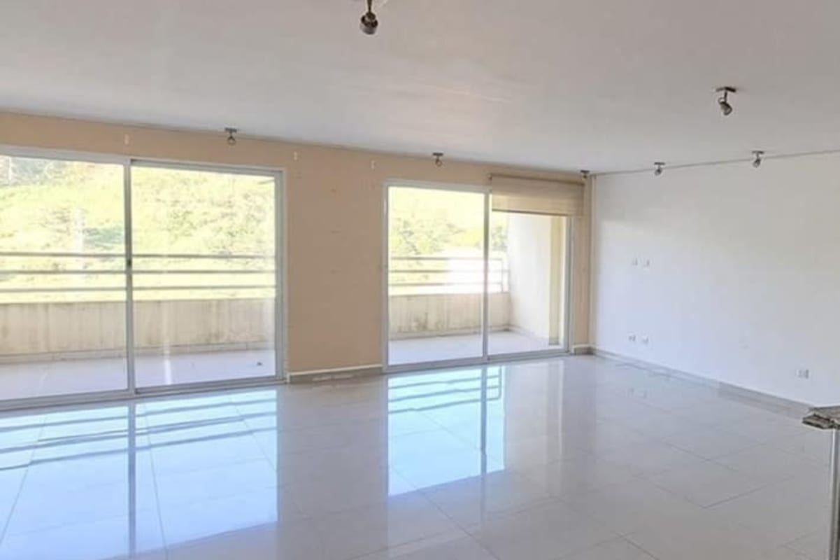 Large living area with sliding glass balcony doors in PH Altamira Gardens Ancon Panama