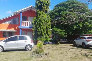 Two-level orange Caribbean style house with balcony and garden Gorgona Panama