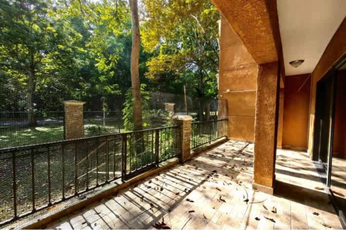 Patio terrace with tile floors iron railing garden view Embassy Club Clayton