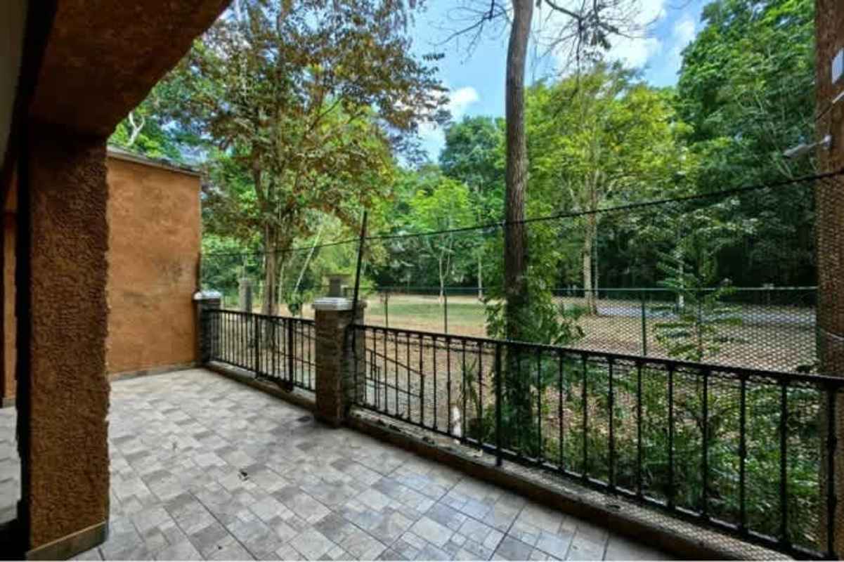Bedroom with large windows, ceiling fan and garden view Embassy Club Clayton
