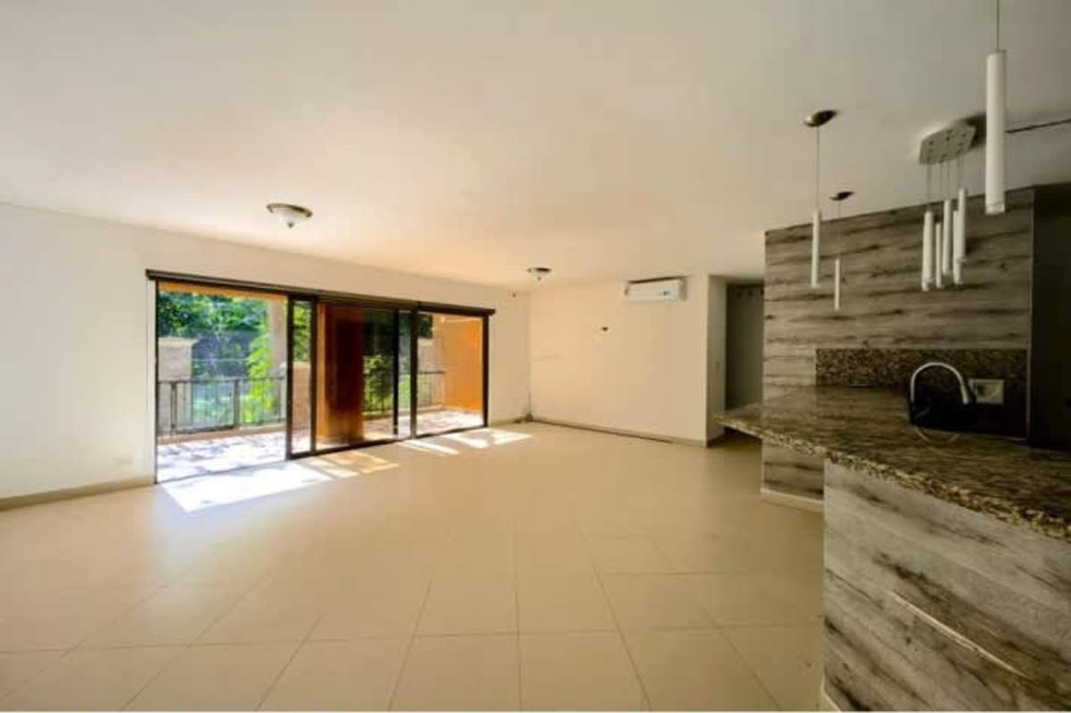 Open-plan living dining leading to terrace with forest views Embassy Club Clayton