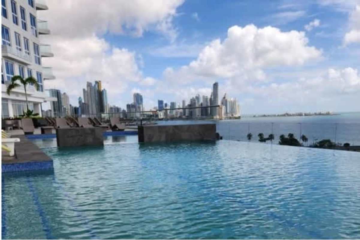 Luxurious rooftop infinity pool overlooking ocean bay and skyline in The Sands Panama