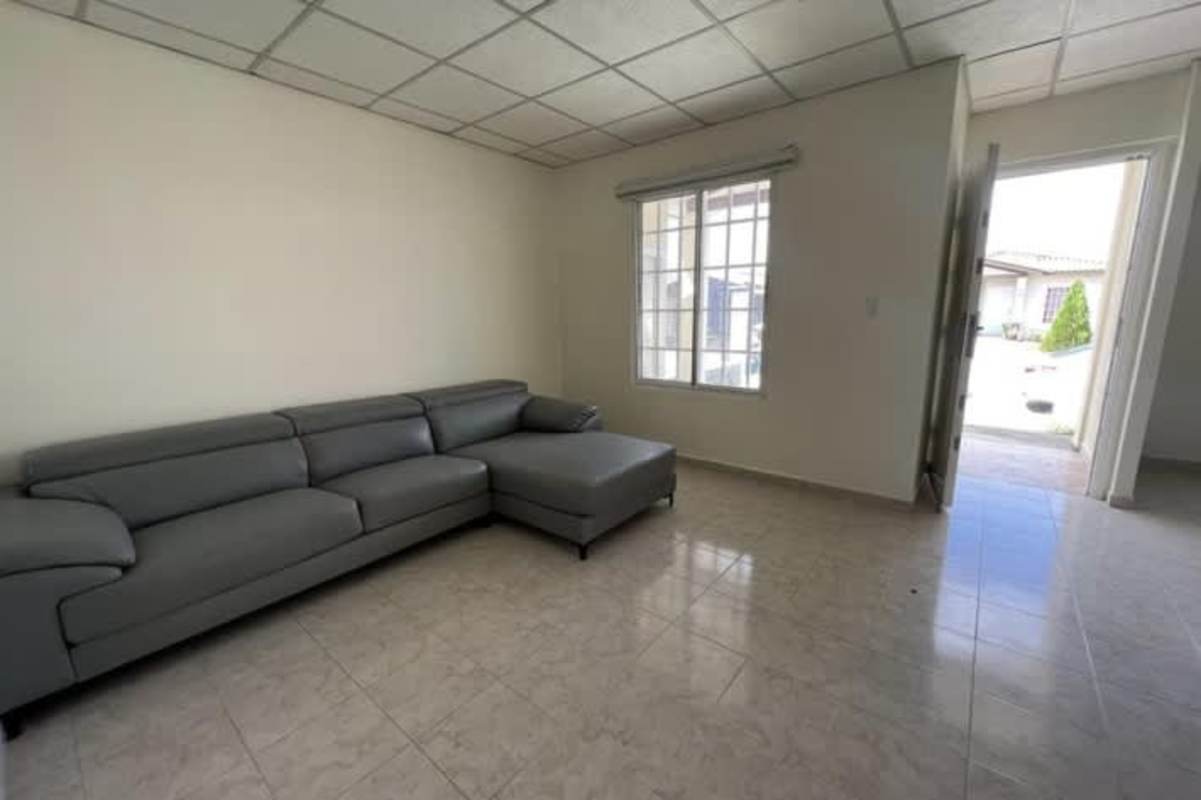 Living room with large windows tiled floor in La Hacienda Tocumen home Panama