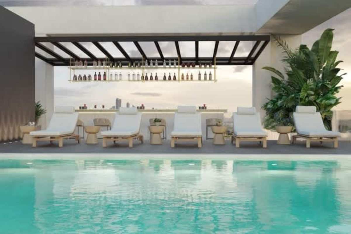 Infinity rooftop pool and outdoor bar area with city skyline backdrop PH The Ivy Santa Maria