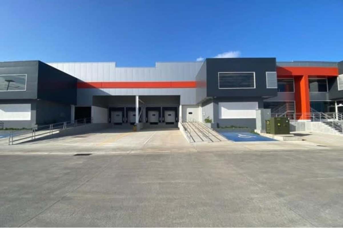Modern warehouse exterior with loading docks and ramp access Panama City Free Zone