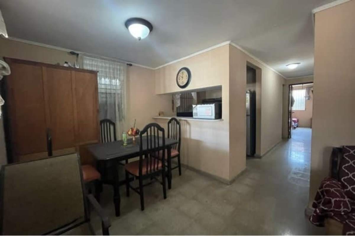 Bedroom with two beds, tiled flooring, window with curtains Villa Lucre Panama