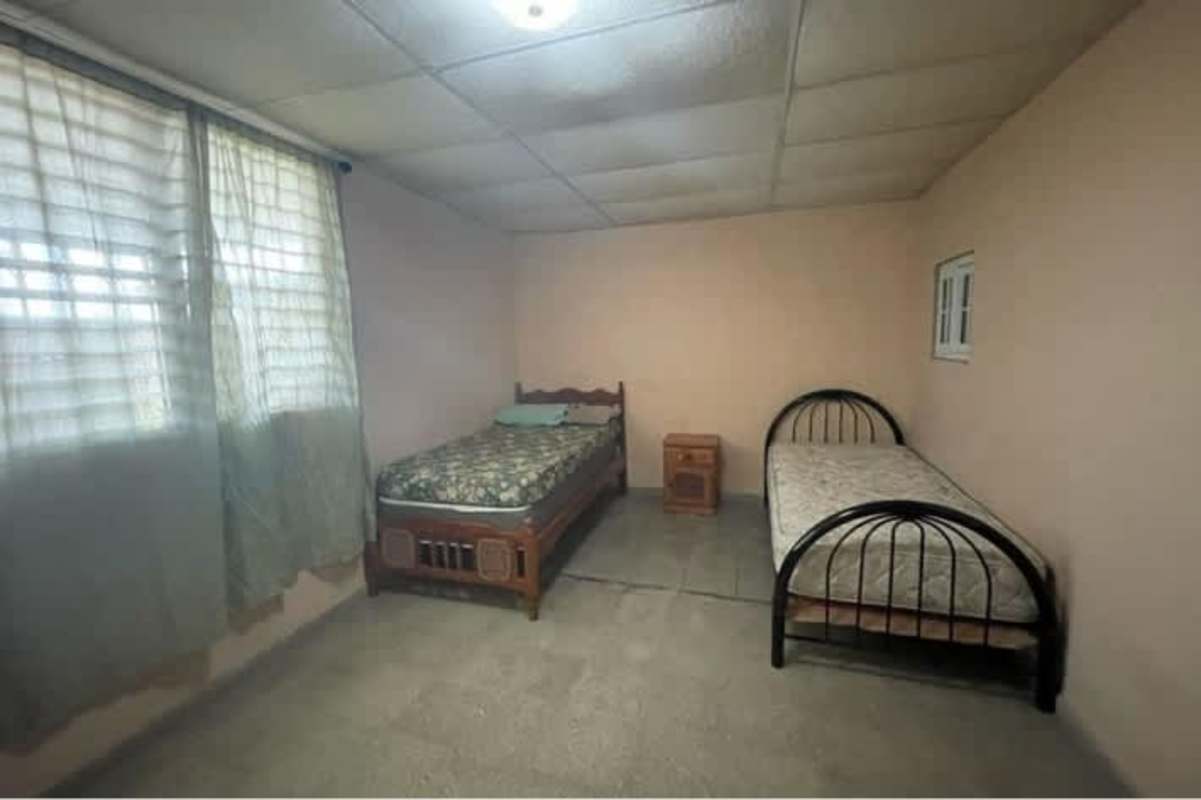 Front covered porch with iron security bars, parking space Villa Lucre Paseo del Valle Panama