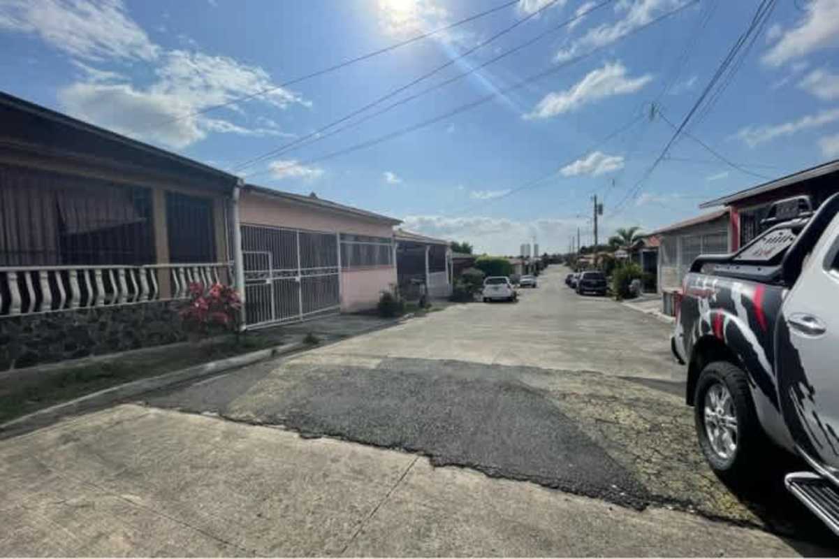 Residential street with driveways gated single level homes in Villa Lucre Panama City