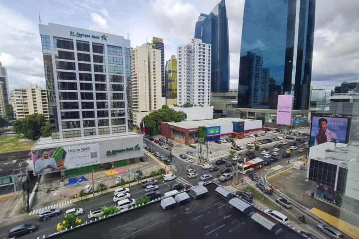 Interior view of versatile office space with exposed ceilings and urban backdrop