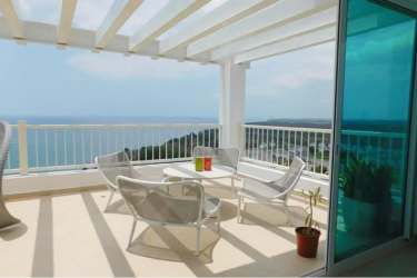 Covered outdoor terrace with panoramic Pacific Ocean views in Bijao Beach Club penthouse Panama