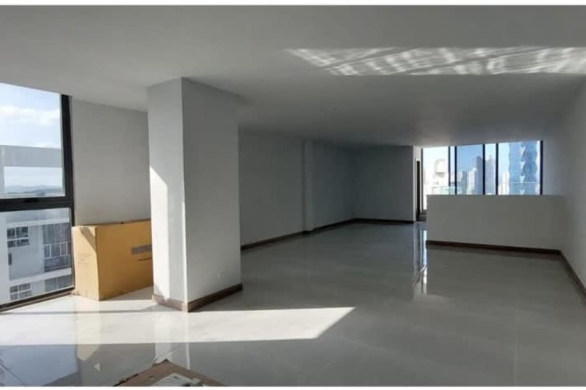 Bright living room with floor-to-ceiling windows and city skyline views duplex apartment Panama