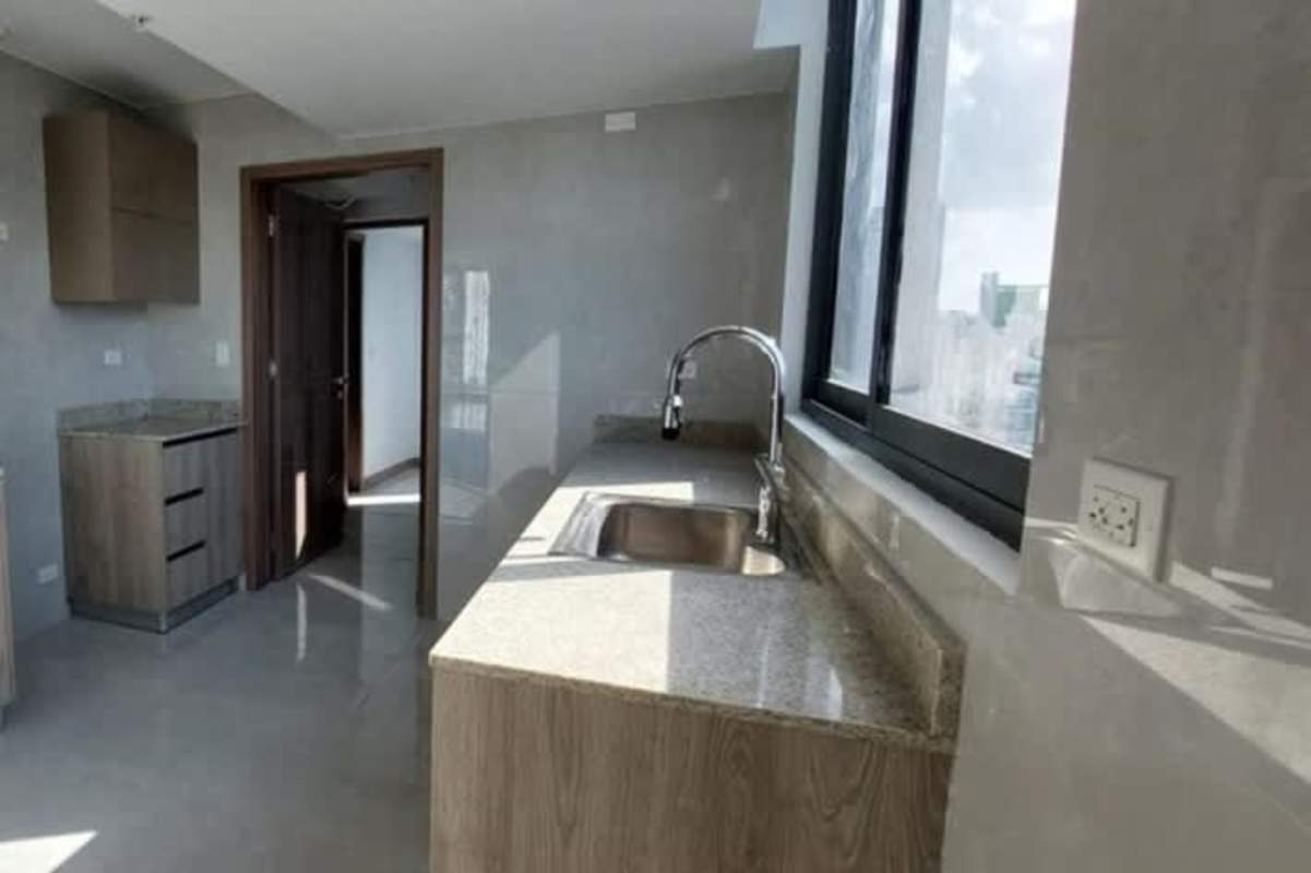 Spacious covered terrace with glass railing and panoramic city skyline views Bella Vista apartment Panama City