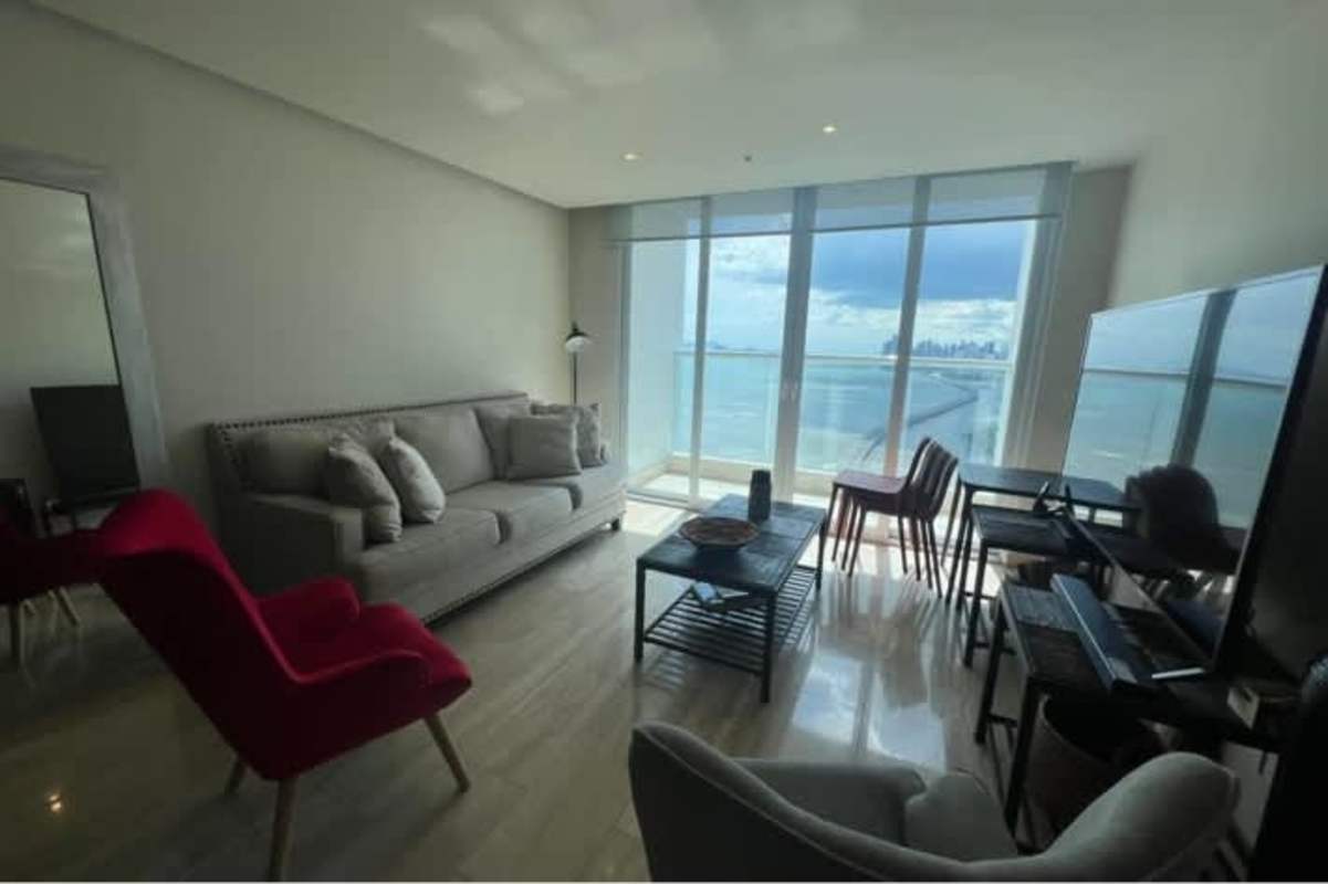 Apartment kitchen with granite counters, stainless steel appliances, white cabinetry in Costa del Este Panama