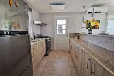 Open kitchen with granite counters and stylish cabinetry in PH Forest Hill