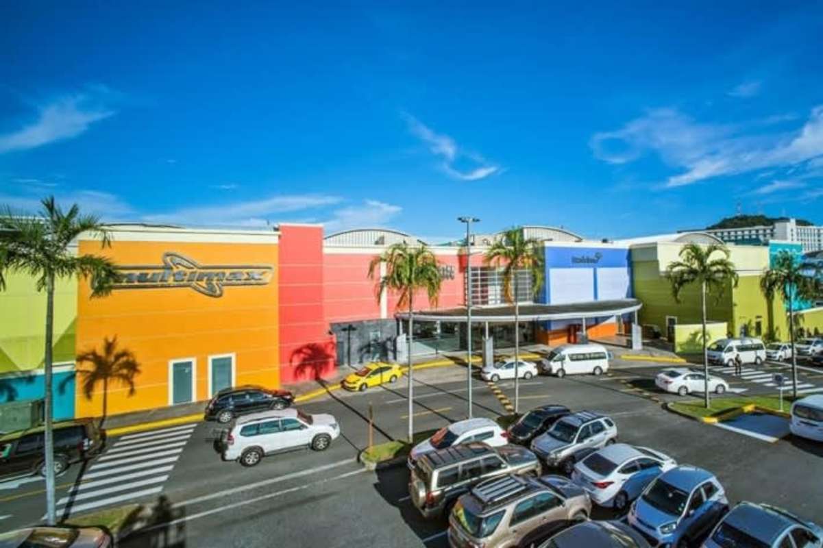 Mall entrance with canopy, parking lot, colorful design in Albrook Mall Panama City