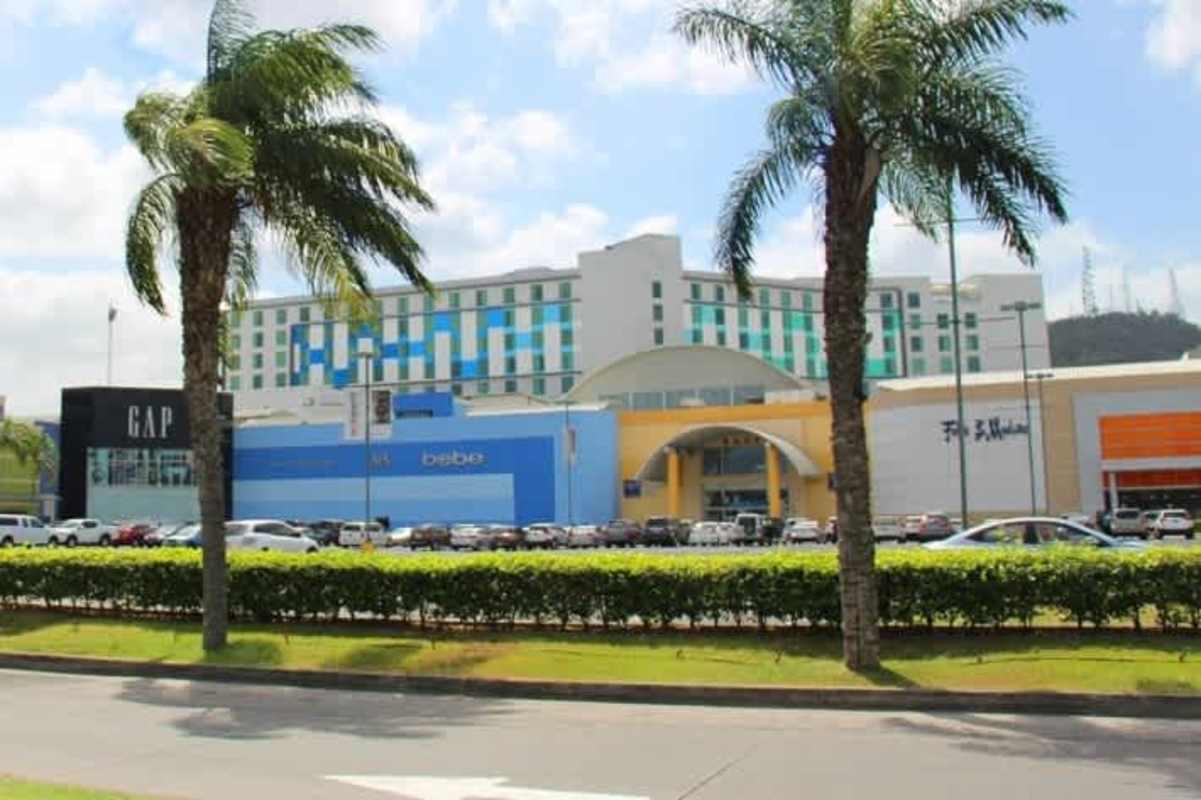 Indoor amusement carousel surrounded by dining tables and colorful play decor inside Albrook Mall Panama City